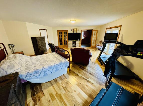 bedroom featuring light hardwood / wood-style flooring and french doors