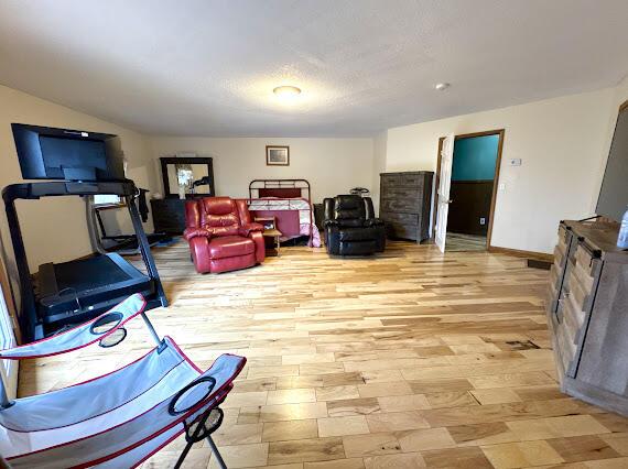 workout room with light hardwood / wood-style flooring