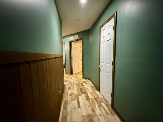 hall with light hardwood / wood-style floors