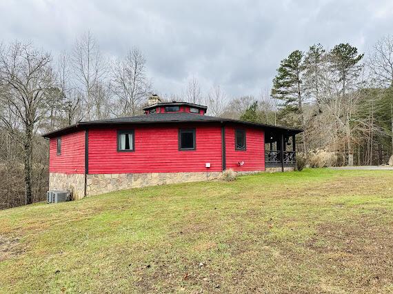 view of property exterior featuring a yard and central air condition unit