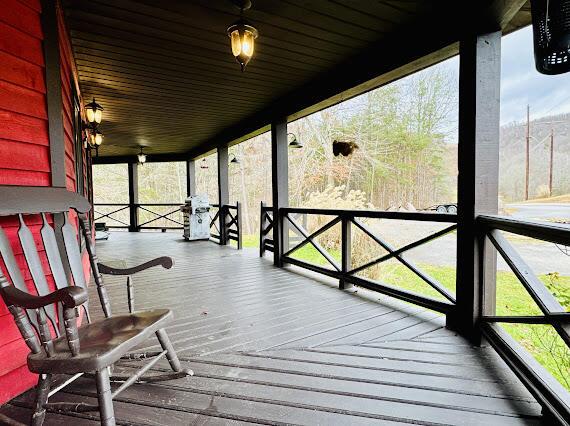 wooden terrace featuring covered porch