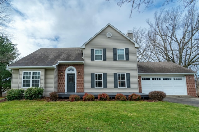 view of front of home with a garage and a front lawn