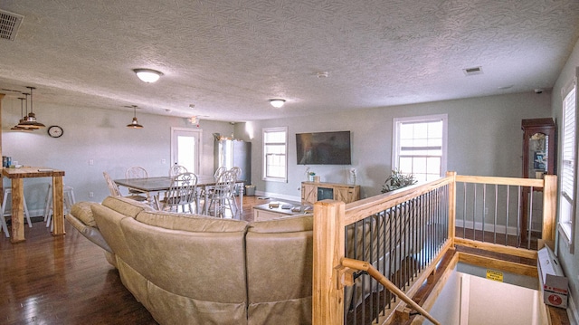 living room with hardwood / wood-style flooring and a textured ceiling