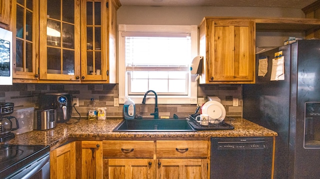 kitchen featuring decorative backsplash, dark stone counters, sink, and stainless steel appliances