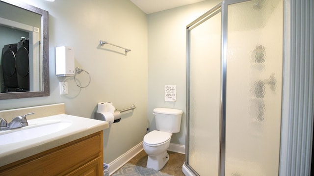 bathroom featuring toilet, a shower with shower door, and vanity