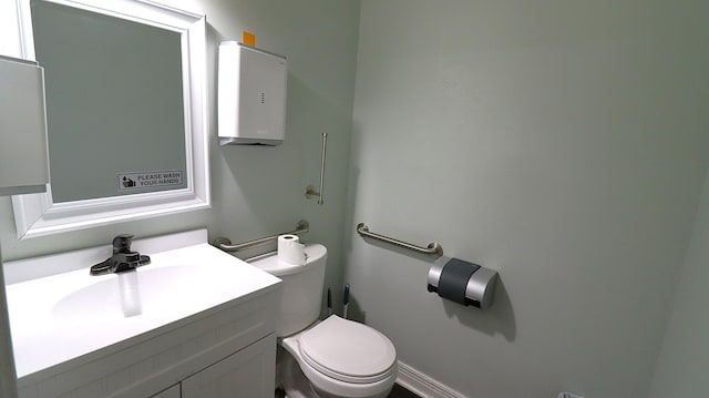 bathroom featuring toilet and vanity