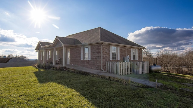 view of side of home featuring a yard