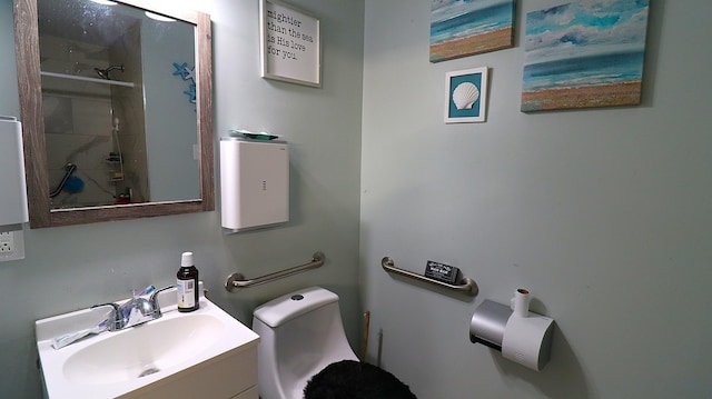 bathroom featuring a shower, toilet, and vanity