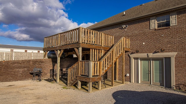 rear view of house featuring a patio area and a wooden deck