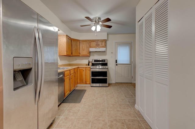 kitchen with ceiling fan, light tile patterned flooring, sink, and appliances with stainless steel finishes