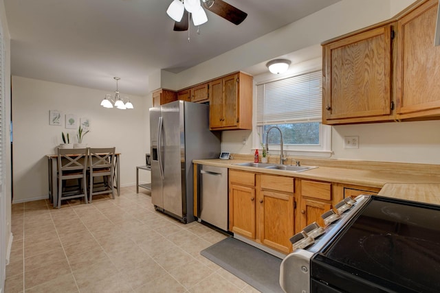 kitchen with decorative light fixtures, ceiling fan with notable chandelier, sink, and appliances with stainless steel finishes