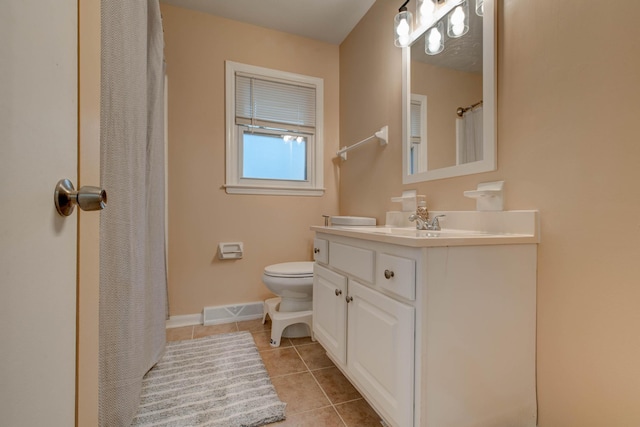 bathroom with tile patterned floors, vanity, and toilet