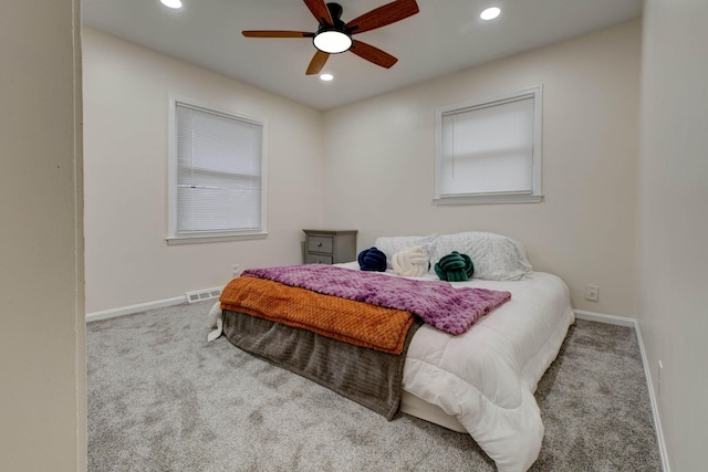 bedroom featuring light colored carpet and ceiling fan