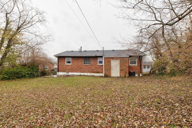 rear view of property with a yard and central AC