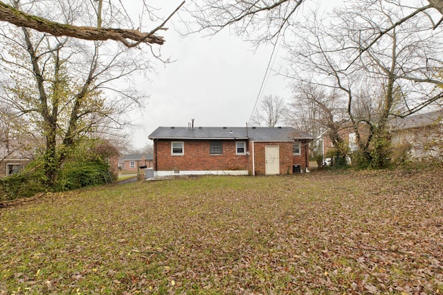 back of property featuring a lawn