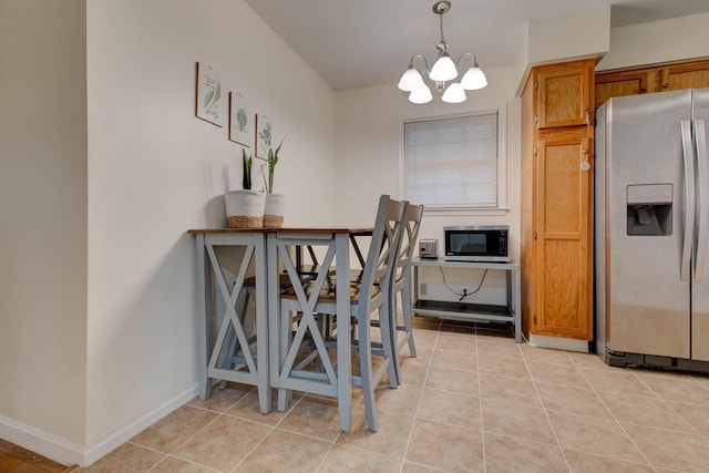 tiled dining space with a notable chandelier