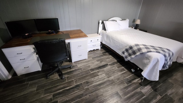 bedroom with wood walls