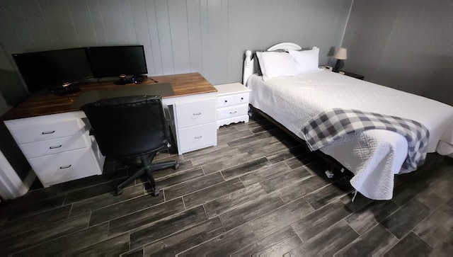 bedroom with wooden walls