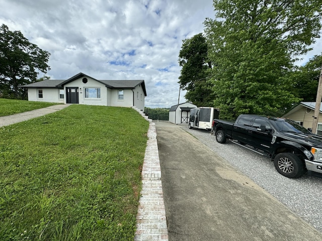 view of front of property with a shed and a front yard