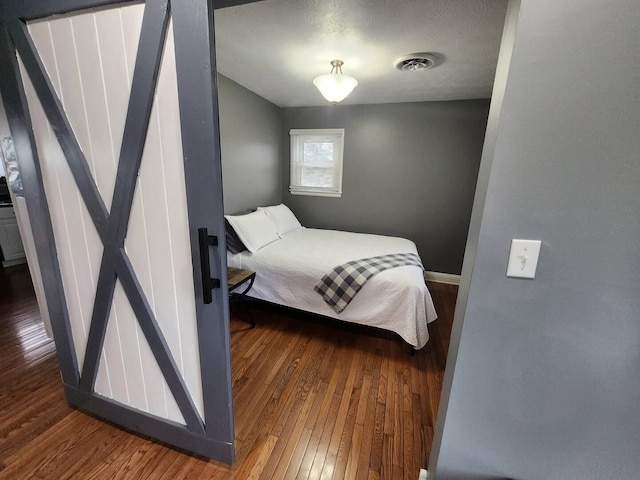 bedroom featuring dark wood-type flooring