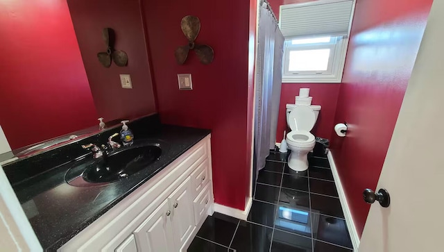 bathroom featuring tile patterned flooring, vanity, and toilet