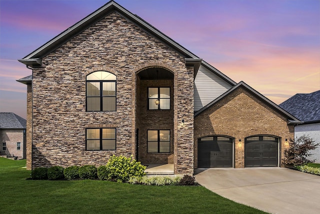 view of front facade with driveway, brick siding, an attached garage, and a front yard