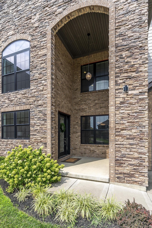 doorway to property featuring brick siding