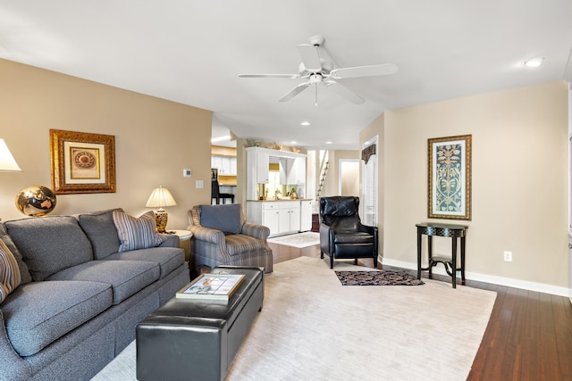 living room featuring ceiling fan and wood-type flooring