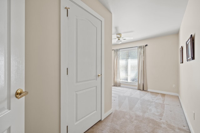 hallway featuring light colored carpet