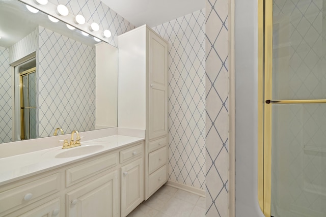 bathroom with vanity and a shower with shower door