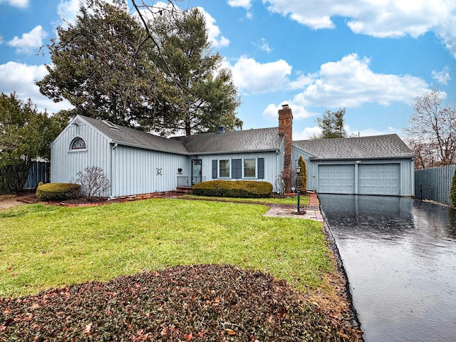 ranch-style home with a garage and a front lawn