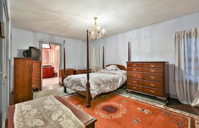 bedroom with a notable chandelier and ensuite bath