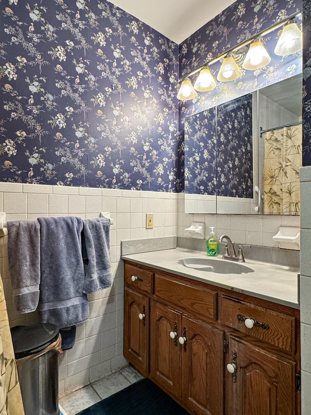 bathroom with vanity and tile walls