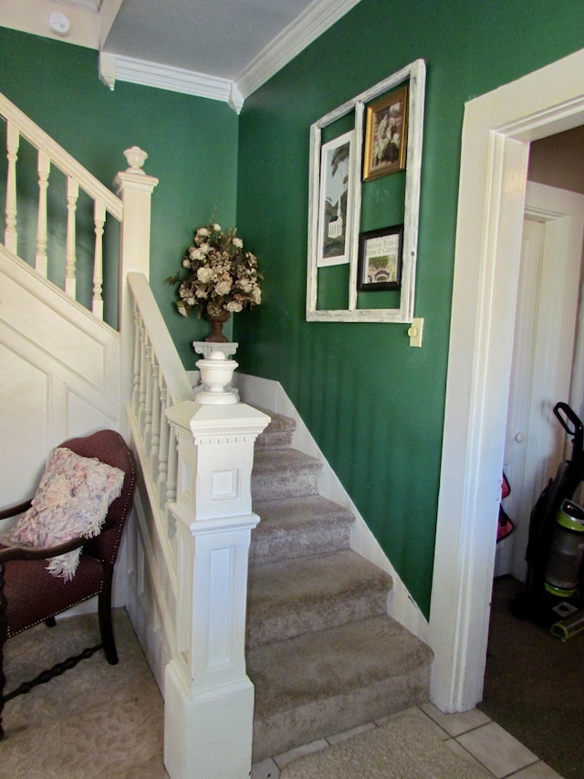 stairs with crown molding and tile patterned floors