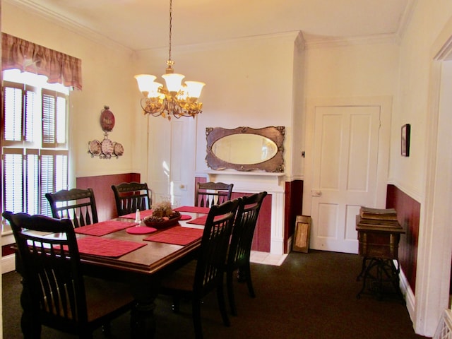 carpeted dining area with an inviting chandelier and ornamental molding