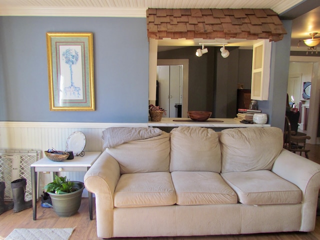 living room featuring hardwood / wood-style flooring and crown molding