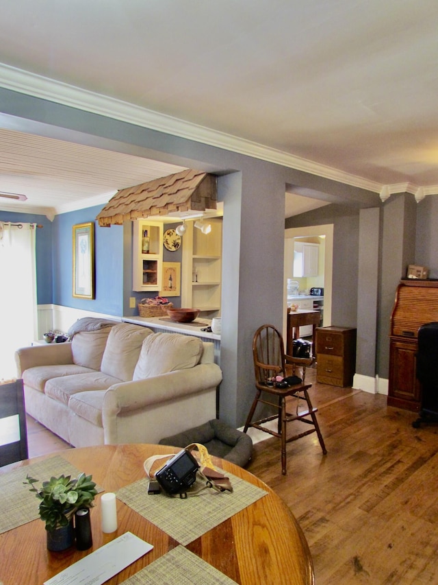 living room with hardwood / wood-style floors and ornamental molding