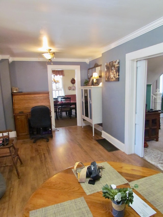 unfurnished living room featuring ornamental molding and hardwood / wood-style floors