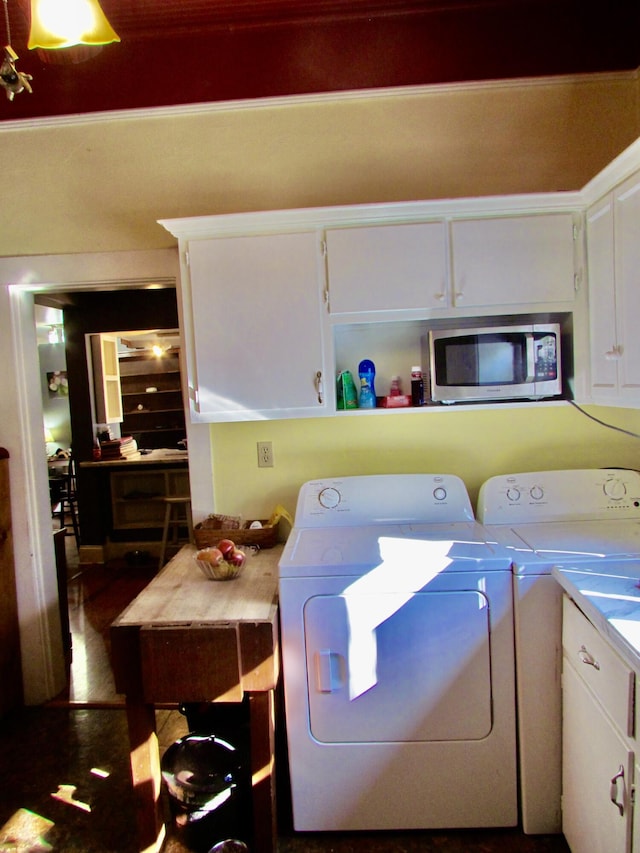 washroom featuring cabinets, independent washer and dryer, and dark wood-type flooring