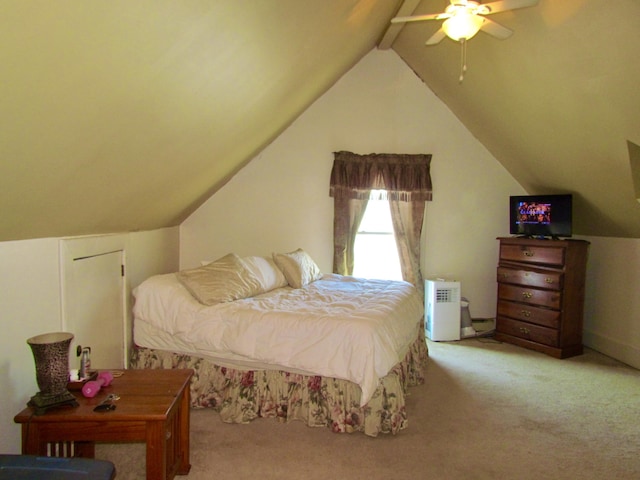 carpeted bedroom featuring ceiling fan and vaulted ceiling with beams