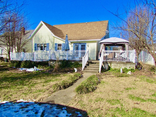 bungalow featuring a gazebo, a wooden deck, and a front yard