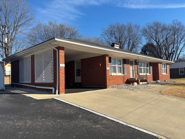 single story home featuring a carport