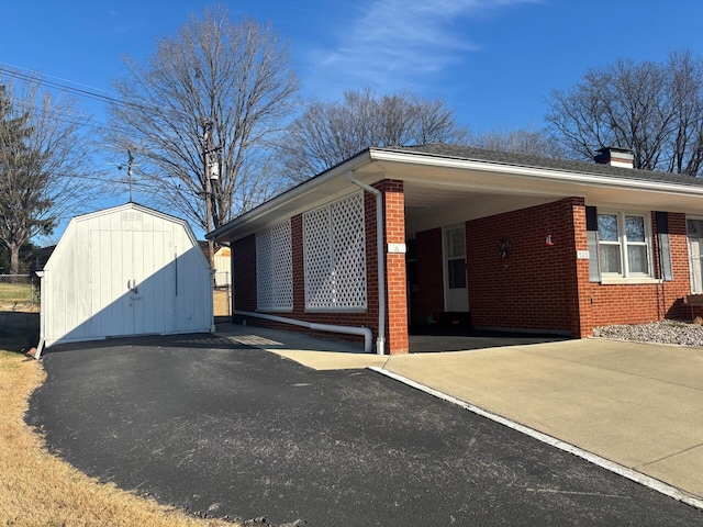 view of front of house with a shed and a carport