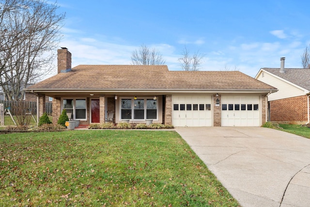 ranch-style house featuring a front yard and a garage