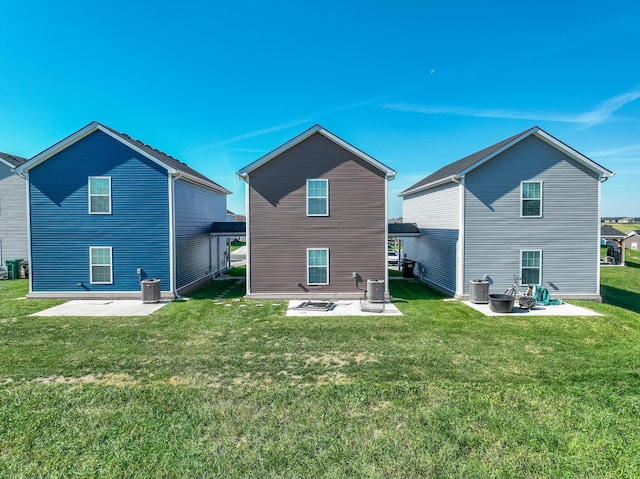 rear view of property featuring a lawn, central air condition unit, and a patio