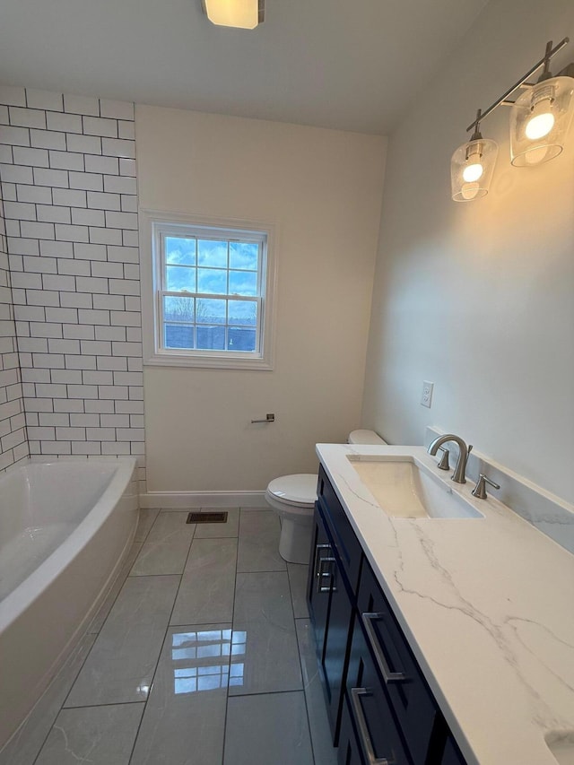 full bathroom with vanity, tiled shower / bath, tile patterned flooring, and toilet