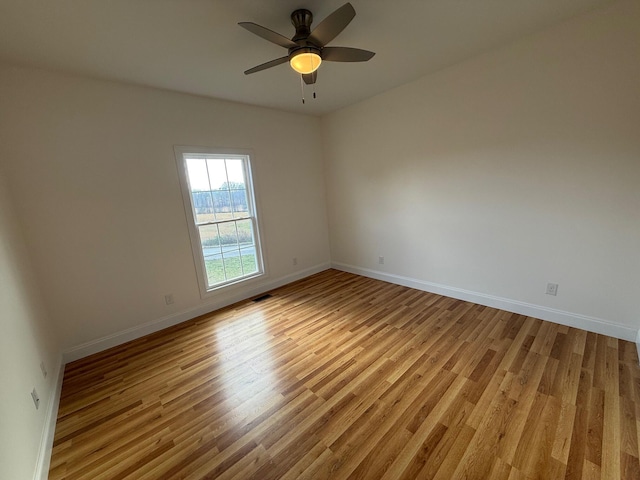 empty room with light hardwood / wood-style flooring and ceiling fan