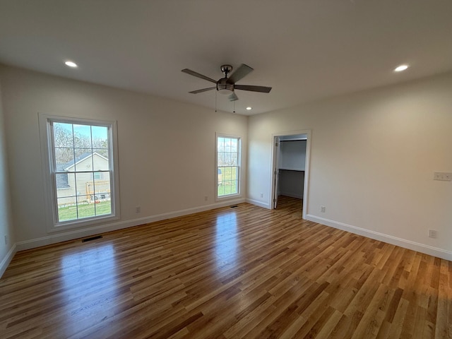 unfurnished room featuring ceiling fan and light wood-type flooring