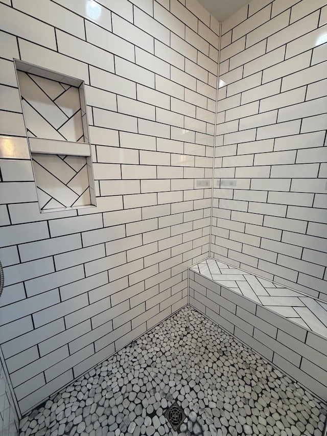 bathroom with tiled shower