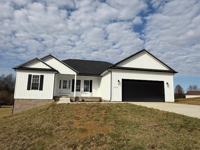 view of front of house with a garage and a front lawn